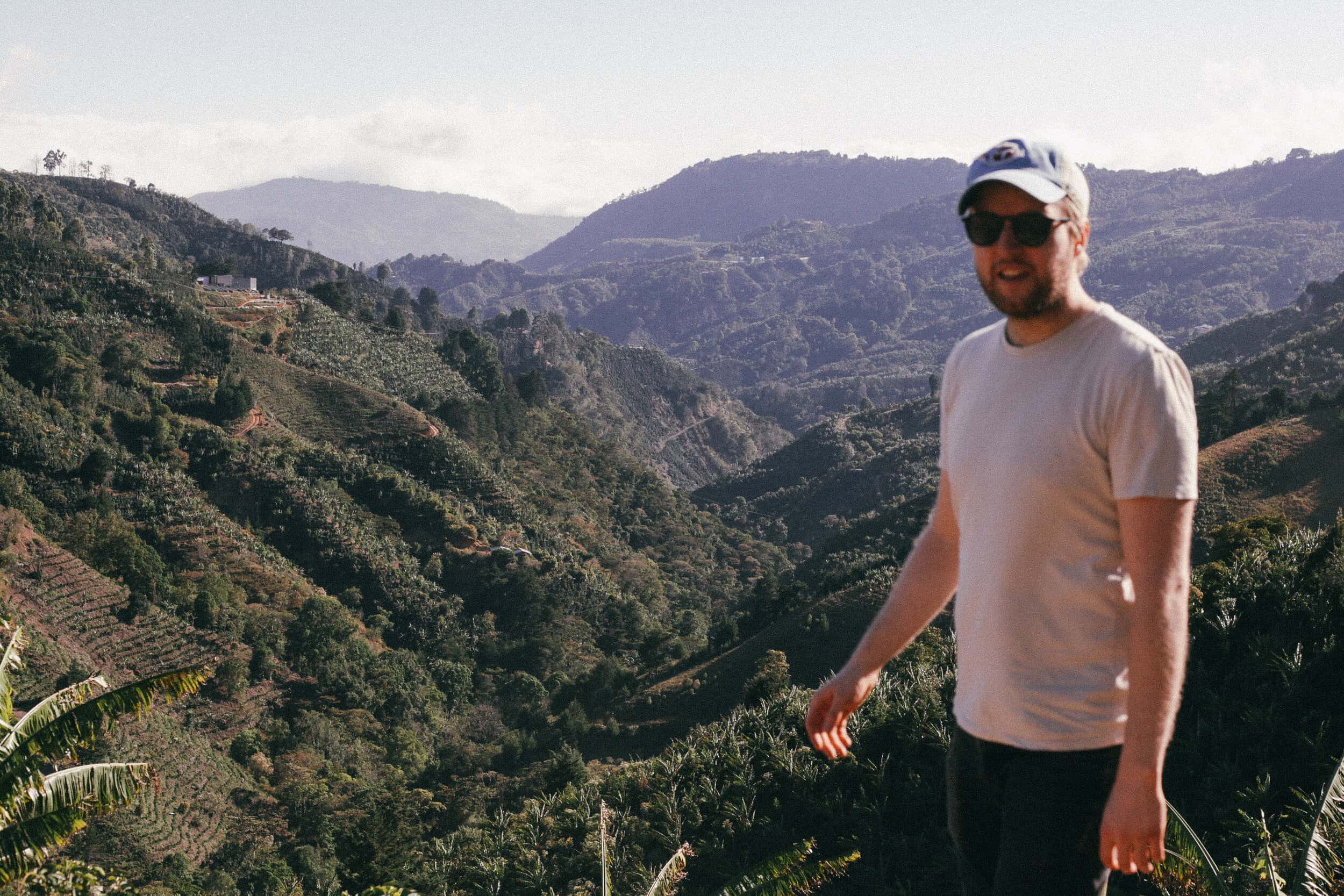 sean, barista from Crema stands on a coffee farm